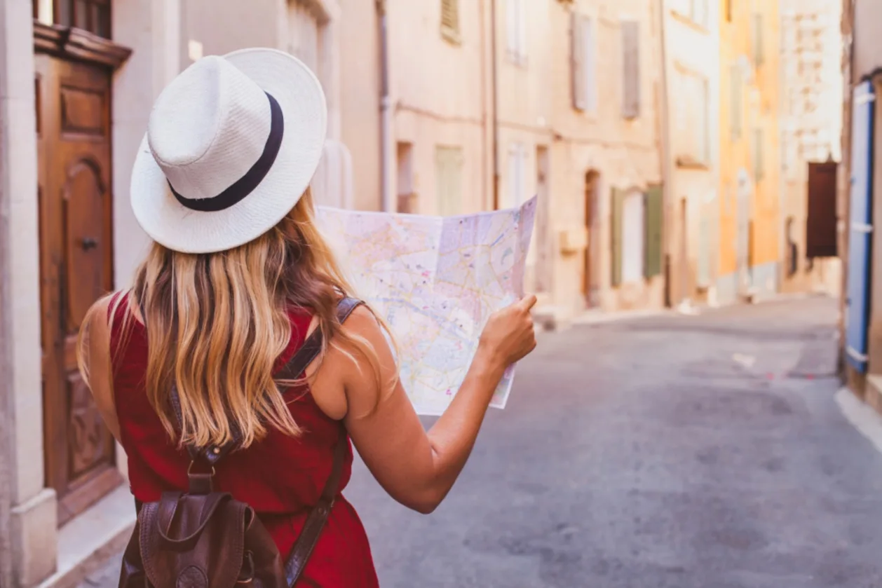 introvert solo woman traveler with map on street in europe
